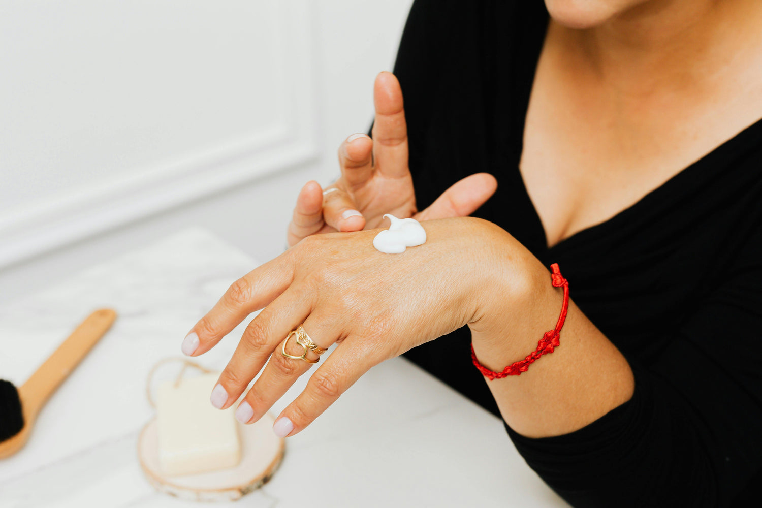 Application of product from all-natural skincare bundles on a hand, showcasing hydration and care